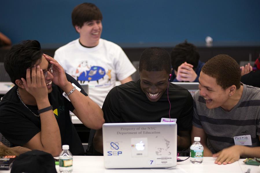 Students laughing at a hackathon